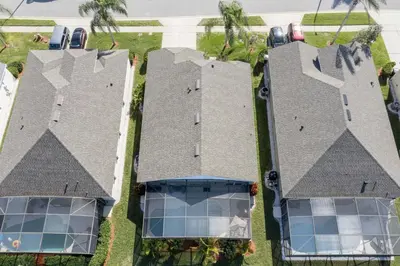 an overhead view of three roofs with solar panels at Villa Helena, Windsor Palms in Kissimmee