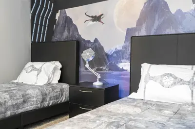 a bedroom with two beds and a wall mural at Villa Smile, Storey Lake in Kissimmee