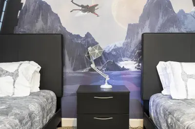 a bedroom with two beds and a lamp on a night stand at Villa Smile, Storey Lake in Kissimmee