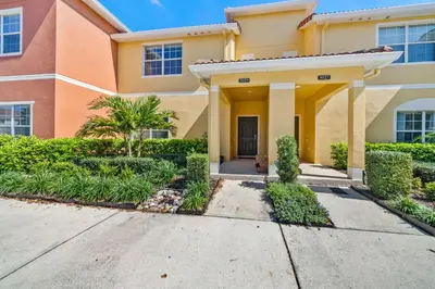 a house with a driveway in front of it at Lakefront 4 Bed private Oasis Location in Kissimmee