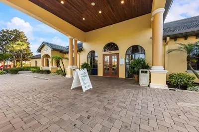 a building with a sign in front of it at Lakefront 4 Bed private Oasis Location in Kissimmee