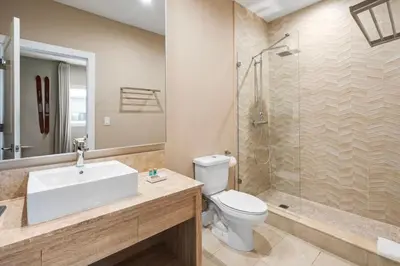 a bathroom with a toilet and a sink and a shower at 4BD and 4.5BA Amazing Villa with Private Hot Tub (3091) in Orlando