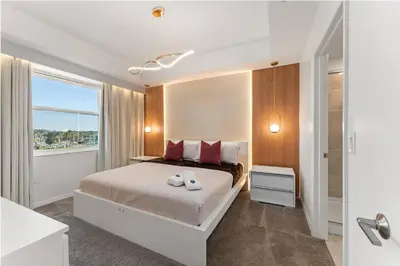 a bedroom with a bed with red pillows and a window at 304 Storey Lake new 6guests 2 BDRS near lakeClub in Kissimmee