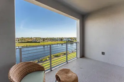 a room with a balcony with a large window at 304 Storey Lake new 6guests 2 BDRS near lakeClub in Kissimmee