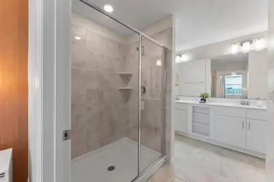 a bathroom with a shower with a glass door at 304 Storey Lake new 6guests 2 BDRS near lakeClub in Kissimmee