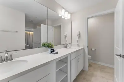 a white bathroom with a sink and a mirror at 304 Storey Lake new 6guests 2 BDRS near lakeClub in Kissimmee