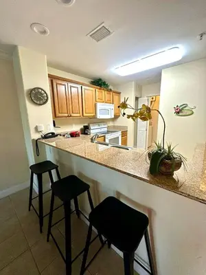 a kitchen with two stools at a kitchen counter at Heron Lake in Orlando