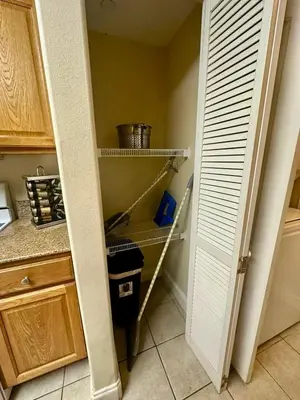 a kitchen with a pantry with a pantry door open at Heron Lake in Orlando