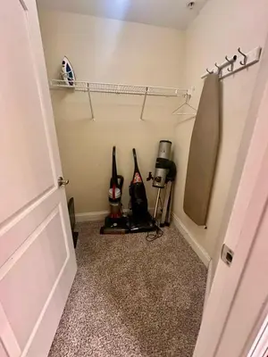 a room with a closet with two bottles of wine at Heron Lake in Orlando