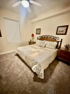a bedroom with a bed and a ceiling fan at Heron Lake in Orlando