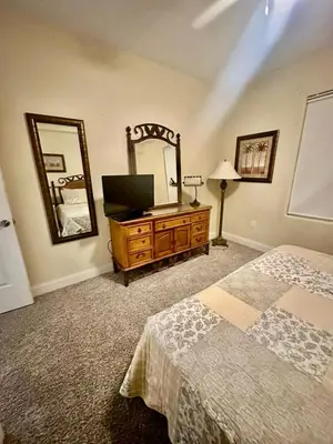 a bedroom with a bed and a dresser with a mirror at Heron Lake in Orlando