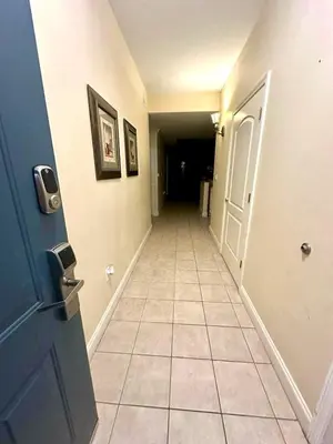 a hallway with a door and a tiled floor at Heron Lake in Orlando