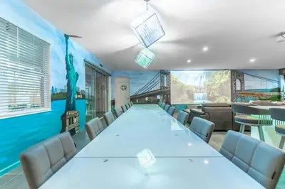 a conference room with a long table and chairs at Brand New 15BR Mansion Pool Spa Close to Disney in Kissimmee