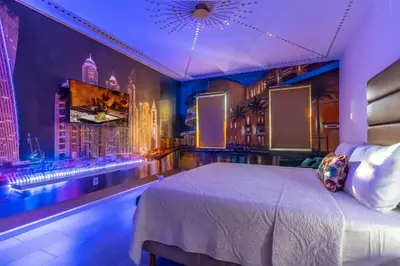 a bedroom with a large bed and a bar at Brand New 15BR Mansion Pool Spa Close to Disney in Kissimmee