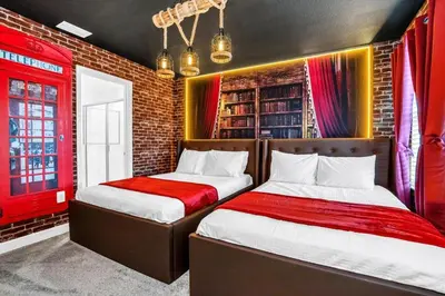 two beds in a room with red and yellow curtains at Brand New High End 9BR Villa in Storey Lake Resort in Kissimmee