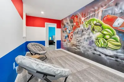a room with a superhero mural on the wall at Brand New Storey Lake 8BR Villa with Lake View in Kissimmee