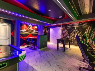 a game room with a ping pong table and purple lighting at Brand New Storey Lake 9BR Villa Summer Kitchen in Kissimmee