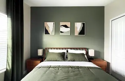 a bedroom with a bed with four pictures on the wall at 4184PD Weekly Stay 5BR Free Water Park in Kissimmee