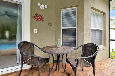 a table and two chairs on a patio at 11326 CYPRESS TRAIL DRIVE ORLANDO 3BED in Orlando