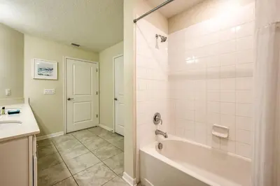 a bathroom with a tub and a sink at 3 Bed Condo Close to Disney at Storey Lake in Kissimmee