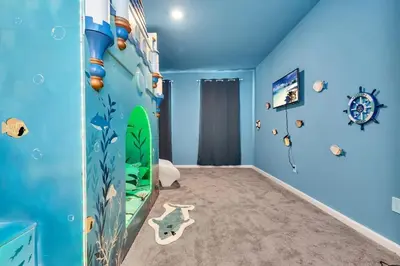 a childs room with a surfboard on the wall at DeepSea World 15 Suites Sleep 30 Oversize Pool Spa in Kissimmee
