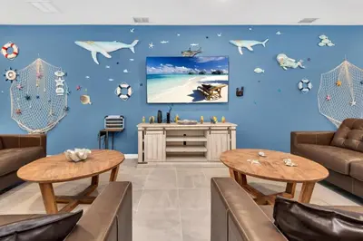 a living room with a blue wall with animals on it at DeepSea World 15 Suites Sleep 30 Oversize Pool Spa in Kissimmee