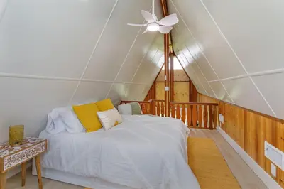 a bedroom with a bed and a ceiling fan at Hope House- Vacation Village 1 Bedroom with Loft in Clermont