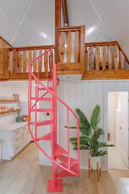 a pink spiral staircase in a kitchen with a plant at Hope House- Vacation Village 1 Bedroom with Loft in Clermont