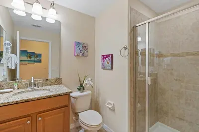 a bathroom with a shower and a toilet and a sink at BCH3071 in Kissimmee