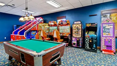 a room with a pool table and arcade games at BCH3071 in Kissimmee