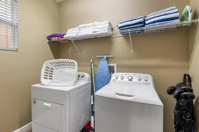 a laundry room with a washing machine and towels at CUP8931 in Kissimmee