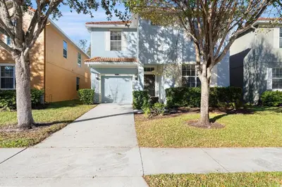 a sidewalk in front of a house with trees at CUP8931 in Kissimmee