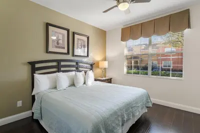 a bedroom with a bed with white pillows and a window at CUP8931 in Kissimmee