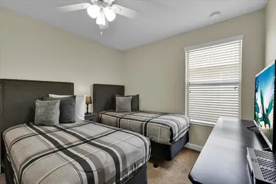 a bedroom with two beds and a desk with a computer at BPD2920 in Kissimmee