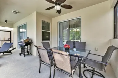 a dining room with a table and chairs and a piano at BPD2920 in Kissimmee