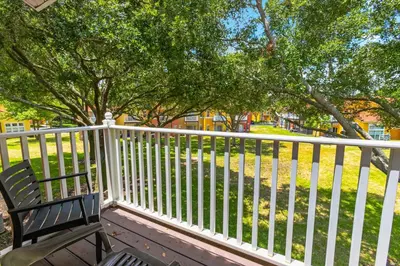 a bench sitting next to a white fence at CCL8538 in Kissimmee