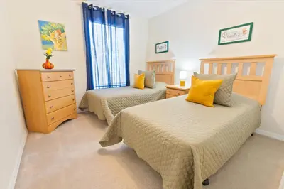 a bedroom with two beds and a dresser at CCL8536 in Kissimmee