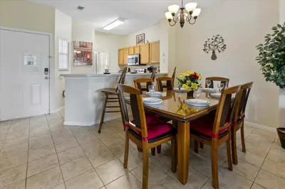 a kitchen and dining room with a table and chairs at CCL8569 in Kissimmee