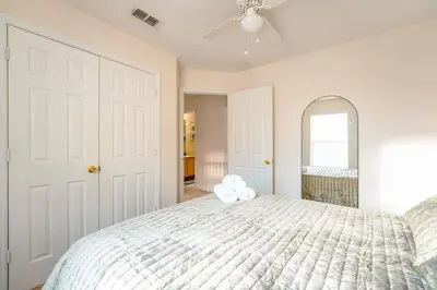a bedroom with a bed with a teddy bear on it at Full House HotTub Mins to UCF in Bithlo