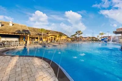 a swimming pool at a resort with blue water at Wonderful 4 bed Family Home with Private Pool in Kissimmee