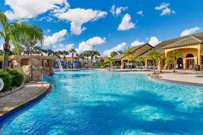 a pool at a resort with palm trees at Wonderful 4 bed Family Home with Private Pool in Kissimmee