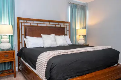 a bedroom with a large bed with white pillows at Classic 8bd house - Encore Reunion Close to Disney in Orlando