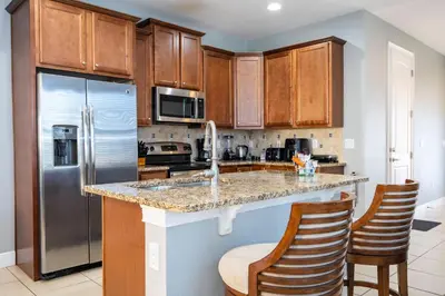 a kitchen with a counter and a refrigerator at Classic 8bd house - Encore Reunion Close to Disney in Orlando