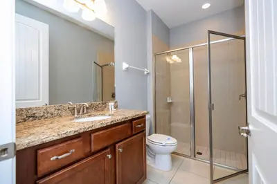 a bathroom with a toilet and a sink and a shower at Classic 8bd house - Encore Reunion Close to Disney in Orlando