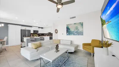 a living room with a white couch and a kitchen at PXC3111-202 in Kissimmee