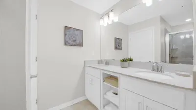 a white bathroom with a sink and a mirror at PXC3111-202 in Kissimmee