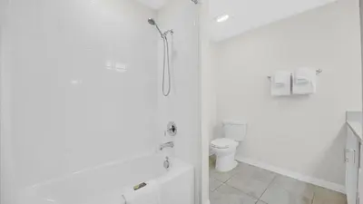 a white bathroom with a shower and a toilet at PXC3111-202 in Kissimmee
