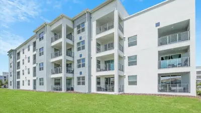 an apartment building with a lawn in front of it at PXC3111-202 in Kissimmee