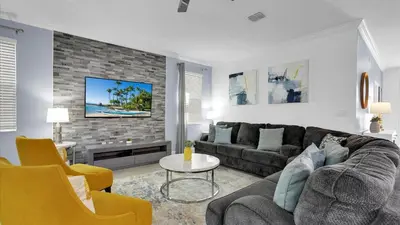 a living room with a couch and a tv at OMW2718 in Kissimmee