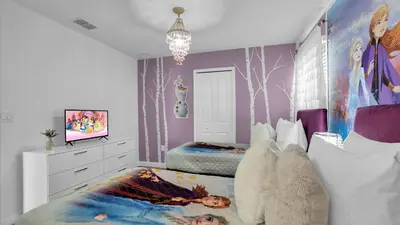 a bedroom with a bed and a painting of trees at OMW2718 in Kissimmee